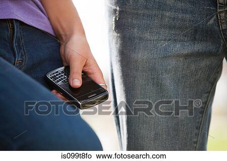 Young person holding smartphone, close up View Large Photo Image Picture - Young person holding smartphone, close up. Fotosearch