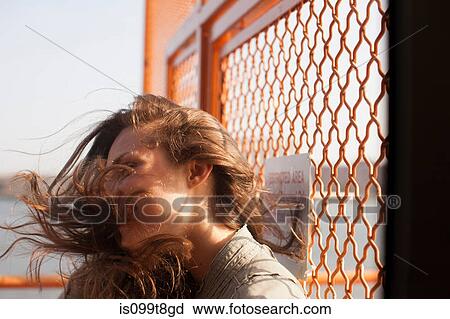 Young woman on a ferry, wind blowing hair View Large Photo Image Stock Image - Young woman on a ferry, wind blowing hair. Fotosearch