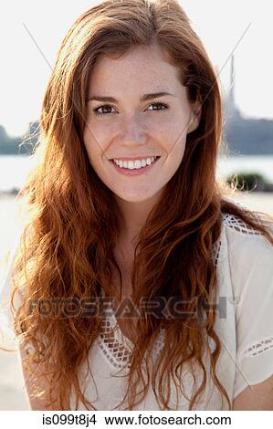 Young woman with long red hair, portrait View Large Photo Image Picture - Young woman with long red hair, portrait. Fotosearch