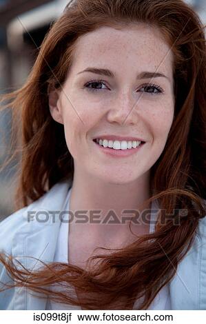 Young woman with long red hair, portrait View Large Photo Image Stock Image - Young woman with long red hair, portrait. Fotosearch
