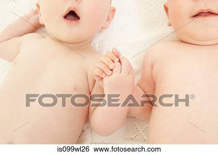 Baby boy and baby girl holding hands View Large Photo Image Stock Photograph - Baby boy and baby girl holding hands. Fotosearch