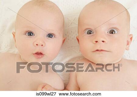 Baby boy and baby girl staring at camera View Large Photo Image Stock Photo - Baby boy and baby girl staring at camera. Fotosearch