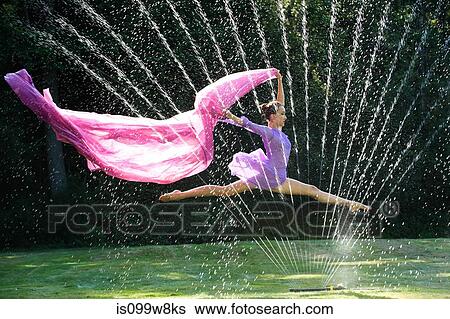 Ballerina leaping over water sprinkler with fabric View Large Photo Image Stock Photograph - Ballerina leaping over water sprinkler with fabric. Fotosearch