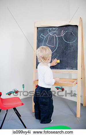 Boy drawing on blackboard View Large Photo Image Stock Image - Boy drawing on blackboard. Fotosearch
