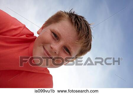 Boy looking at camera, viewed from below View Large Photo Image Stock Image - Boy looking at camera, viewed from below. Fotosearch