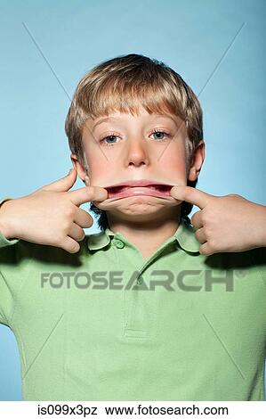 Boy pulling faces View Large Photo Image Stock Photo - Boy pulling faces. Fotosearch