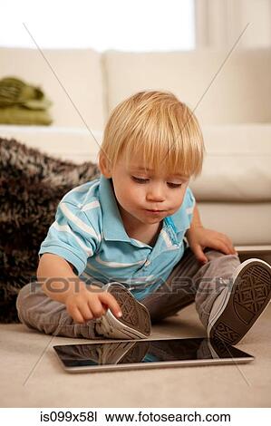 Boy using digital tablet View Large Photo Image Stock Image - Boy using digital tablet. Fotosearch
