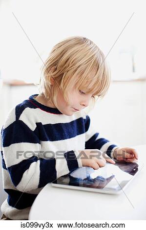 Boy using digital tablet View Large Photo Image Stock Photo - Boy using digital tablet. Fotosearch
