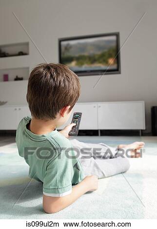 Boy watching television at home View Large Photo Image Picture - Boy watching television at home. Fotosearch