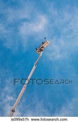 Builders on access platform, low angle View Large Photo Image Stock Image - Builders on access platform, low angle. Fotosearch