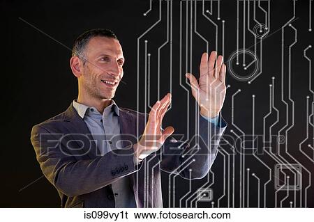Stock Photograph - Businessman touching virtual circuit board symbols. Fotosearch