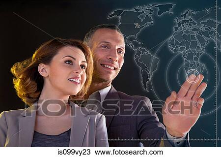 Businesspeople touching world map View Large Photo Image Stock Image - Businesspeople touching world map. Fotosearch
