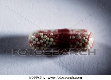 Capsule containing tiny pills View Large Photo Image Stock Photo - Capsule containing tiny pills. Fotosearch