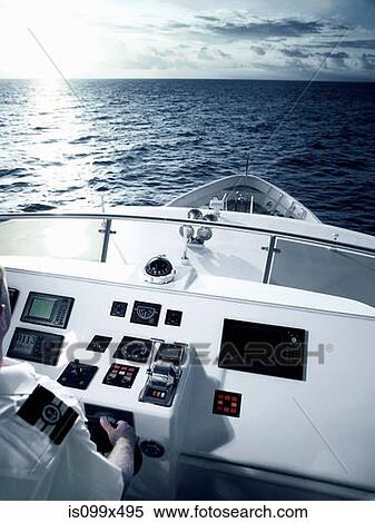 Captain at helm of large motor yacht View Large Photo Image Stock Photography - Captain at helm of large motor yacht. Fotosearch
