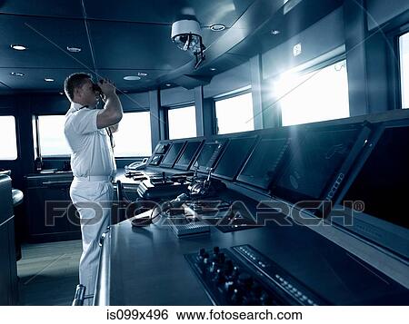 Captain in cockpit of motor yacht, using binoculars View Large Photo Image Stock Photograph - Captain in cockpit of motor yacht, using binoculars. Fotosearch