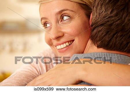 Stock Photo - Close up of couple hugging. Fotosearch