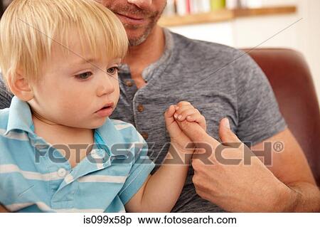 Close up of father holding sons hand View Large Photo Image Stock Photography - Close up of father holding sons hand. Fotosearch