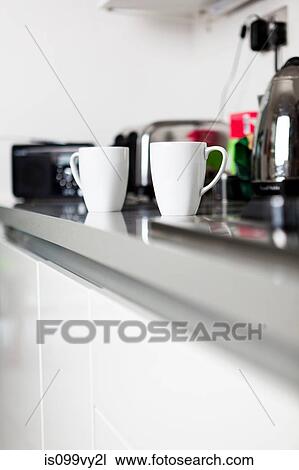 Coffee cups on kitchen counter View Large Photo Image Stock Image - Coffee cups on kitchen counter. Fotosearch