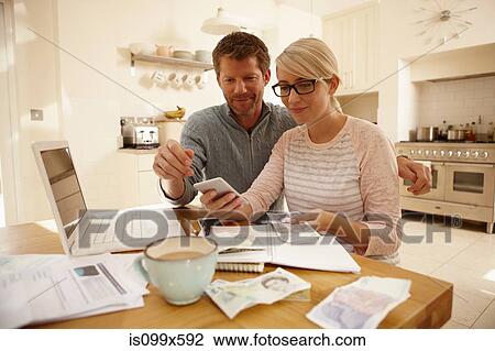 Stock Image - Couple counting money. Fotosearch