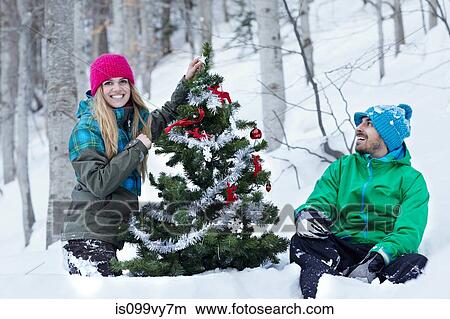 Couple decorating christmas tree View Large Photo Image Picture - Couple decorating christmas tree. Fotosearch