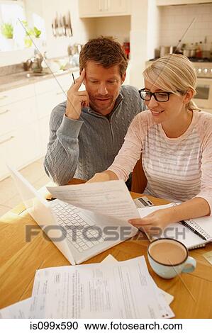 Couple doing paperwork View Large Photo Image Stock Image - Couple doing paperwork. Fotosearch
