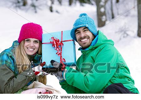 Couple holding christmas gift View Large Photo Image Stock Photo - Couple holding christmas gift. Fotosearch