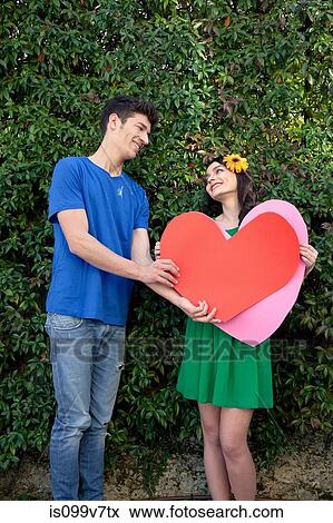 Couple holding heart shape View Large Photo Image Stock Photo - Couple holding heart shape. Fotosearch