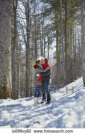Couple kissing in snow View Large Photo Image Stock Image - Couple kissing in snow. Fotosearch