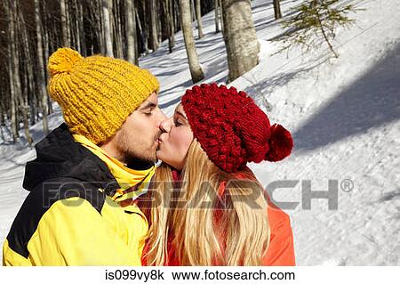 Couple kissing in snow View Large Photo Image Stock Image - Couple kissing in snow. Fotosearch
