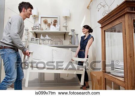 Couple moving sofa View Large Photo Image Picture - Couple moving sofa. Fotosearch