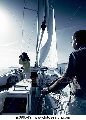 Couple on yacht with binoculars View Large Photo Image Stock Image - Couple on yacht with binoculars. Fotosearch