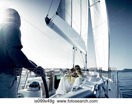 Couple on yacht with camera View Large Photo Image Stock Image - Couple on yacht with camera. Fotosearch