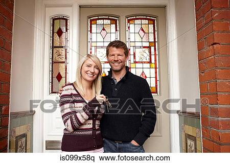 Couple outside new house with house keys View Large Photo Image Stock Photography - Couple outside new house with house keys. Fotosearch