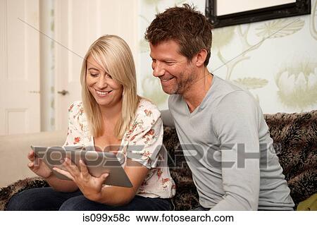 Stock Image - Couple using digital tablet. Fotosearch