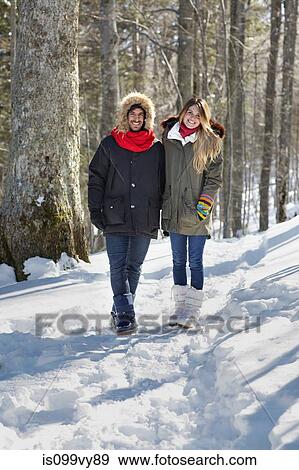 Couple walking in snow View Large Photo Image Stock Photo - Couple walking in snow. Fotosearch