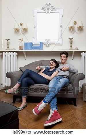 Couple watching tv on sofa View Large Photo Image Stock Image - Couple watching tv on sofa. Fotosearch
