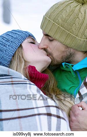 Couple wrapped in blanket, kissing View Large Photo Image Stock Image - Couple wrapped in blanket, kissing. Fotosearch
