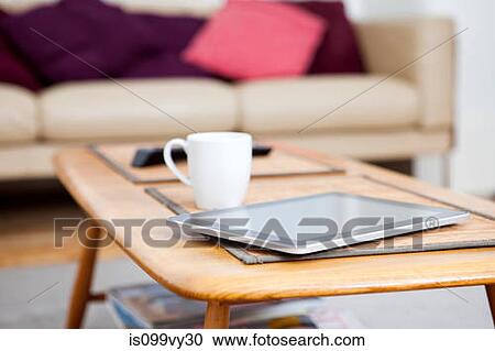 Digital tablet on coffee table View Large Photo Image Stock Image - Digital tablet on coffee table. Fotosearch