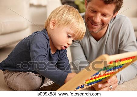 Father and son playing with abacus View Large Photo Image Stock Image - Father and son playing with abacus. Fotosearch