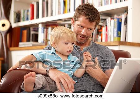 Father and son with laptop View Large Photo Image Picture - Father and son with laptop. Fotosearch