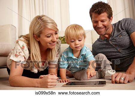 Father, mother and son using digital tablet View Large Photo Image Picture - Father, mother and son using digital tablet. Fotosearch