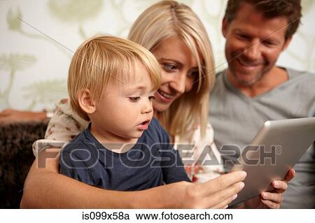 Stock Image - Father, mother and son using digital tablet. Fotosearch