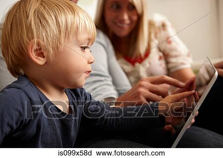 Stock Image - Father, mother and son using digital tablet. Fotosearch