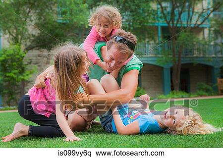 Father playing with his daughters in garden View Large Photo Image Stock Photography - Father playing with his daughters in garden. Fotosearch