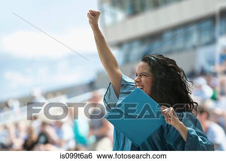 Stock Photograph - Female graduate raising fist. Fotosearch