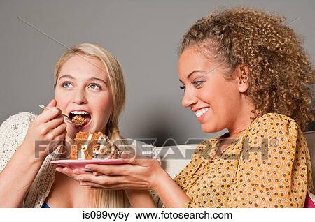 Stock Photo - Friends eating cake. Fotosearch