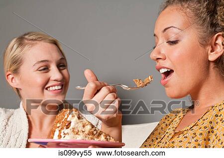 Friends eating cake View Large Photo Image Stock Photography - Friends eating cake. Fotosearch