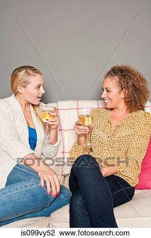 Stock Image - Friends with white wine. Fotosearch