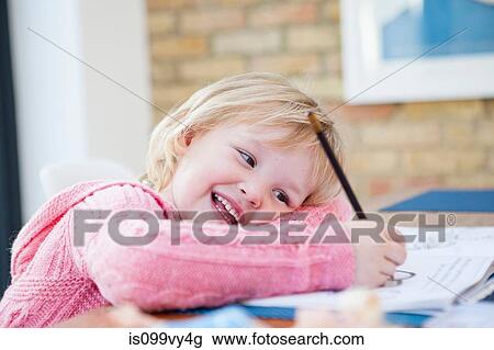 Stock Image - Girl doing homework. Fotosearch