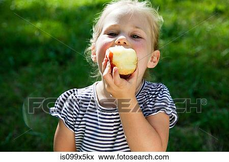 Girl eating apple View Large Photo Image Stock Photo - Girl eating apple. Fotosearch